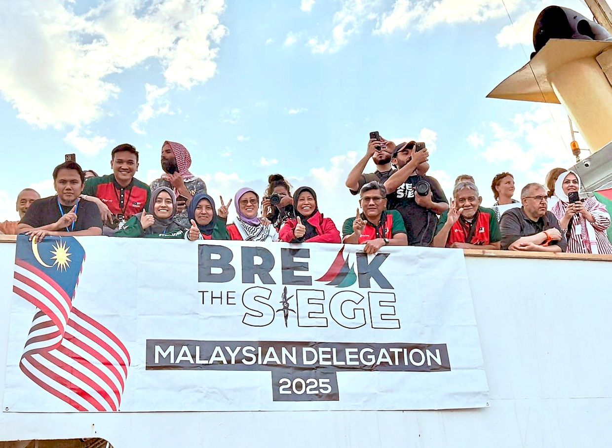 Ready to face the challenge: Astro Awani reporter Syafik (second from left) greeting well-wishers alongside medical and media personnel on board the vessel Conscience, currently en route to Gaza as part of the second wave of the Global Sumud Flotilla.
