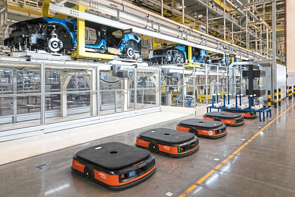 The rise of the robot nation 1 Robotic carts being readied for hauling heavy loads around the assembly lines at the Zeekr auto plant in Ningbo. — Qilai Shen/The New York Times