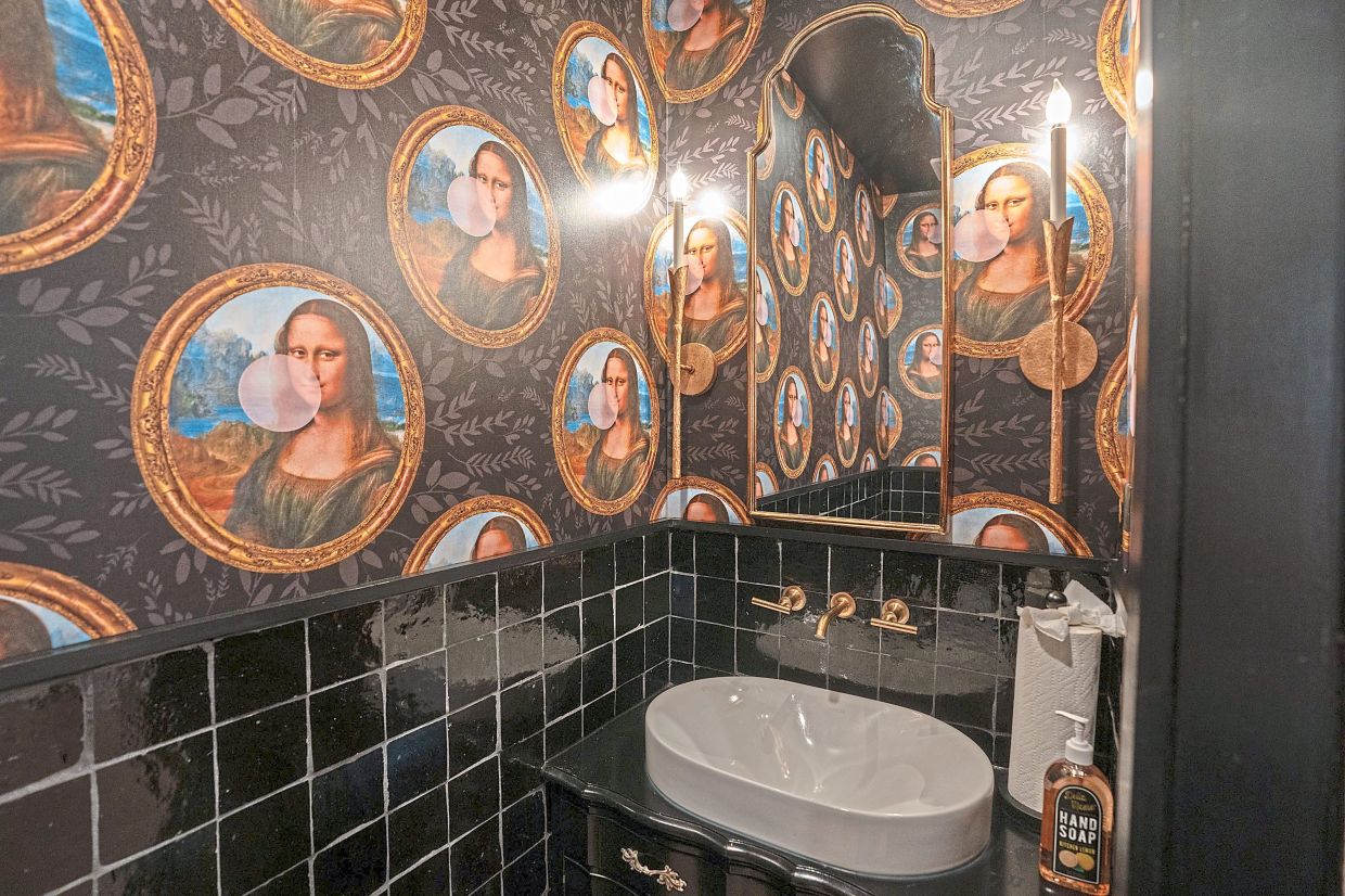A renovated bathroom in Mays' Upper Darby home features the Mona Lisa blowing pink bubbles.
