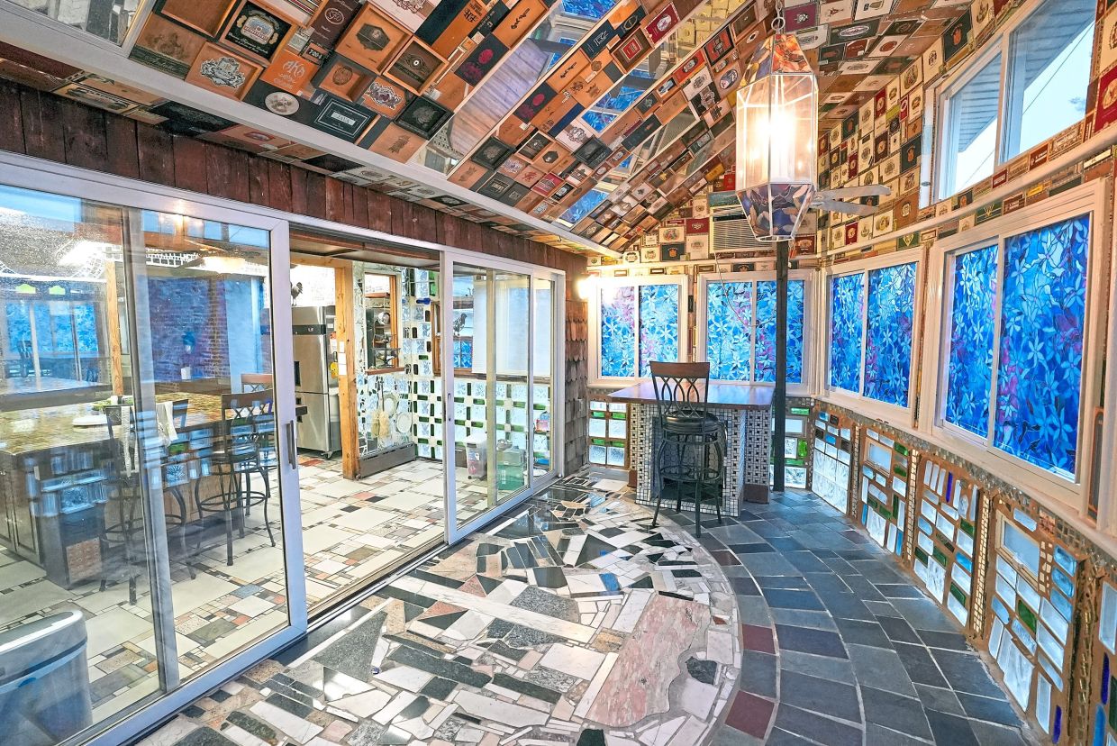 The sunroom was wallpapered with cigar boxes before the renovation. — HGTV/TNS