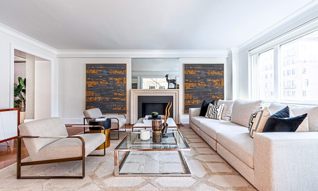 Two identical pieces of art serve to anchor this living room.