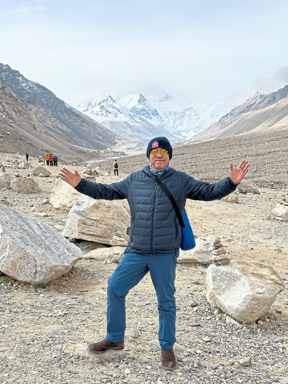 The writer at the EBC with a view of the stunning Mount Everest in the background. 