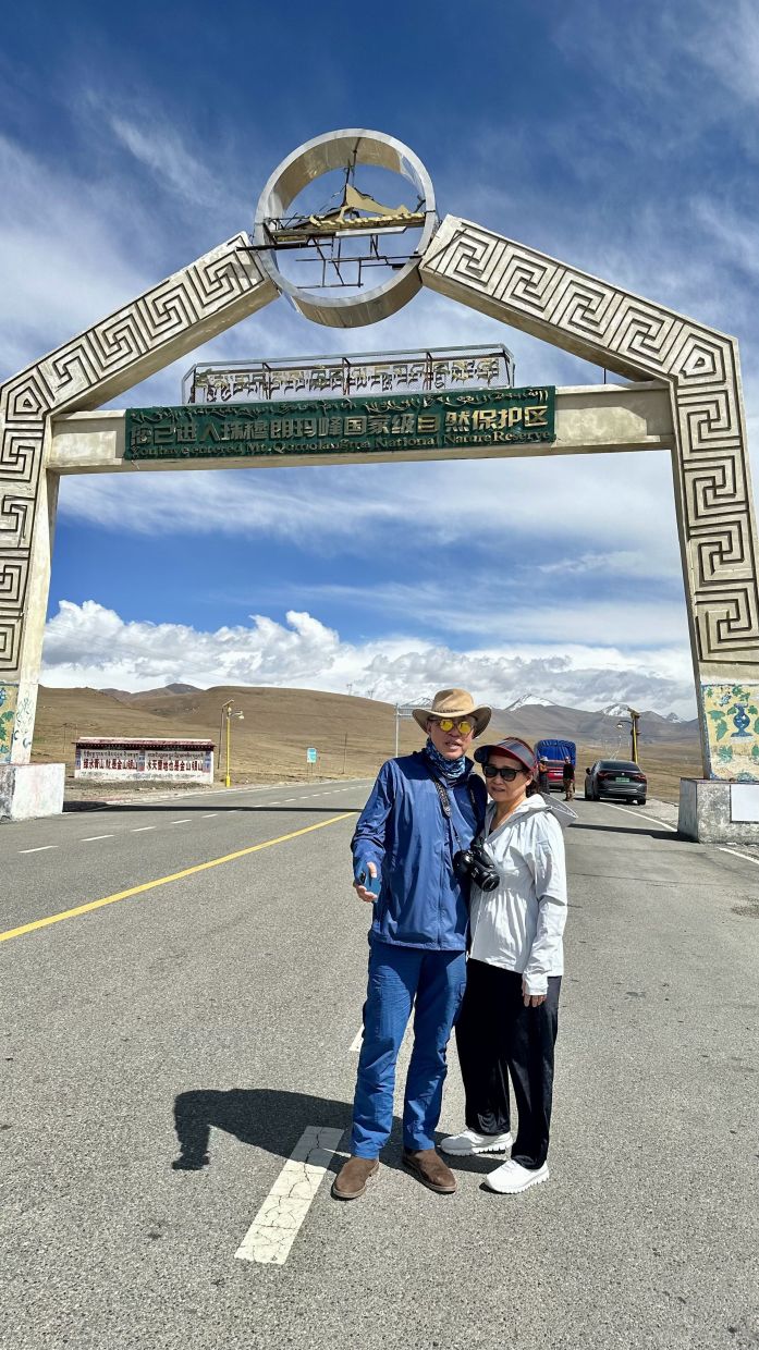 The writer and his wife Florence, who was already experiencing altitude sickness when this picture was taken below the arch of the gateway into the Mount Everest national park.