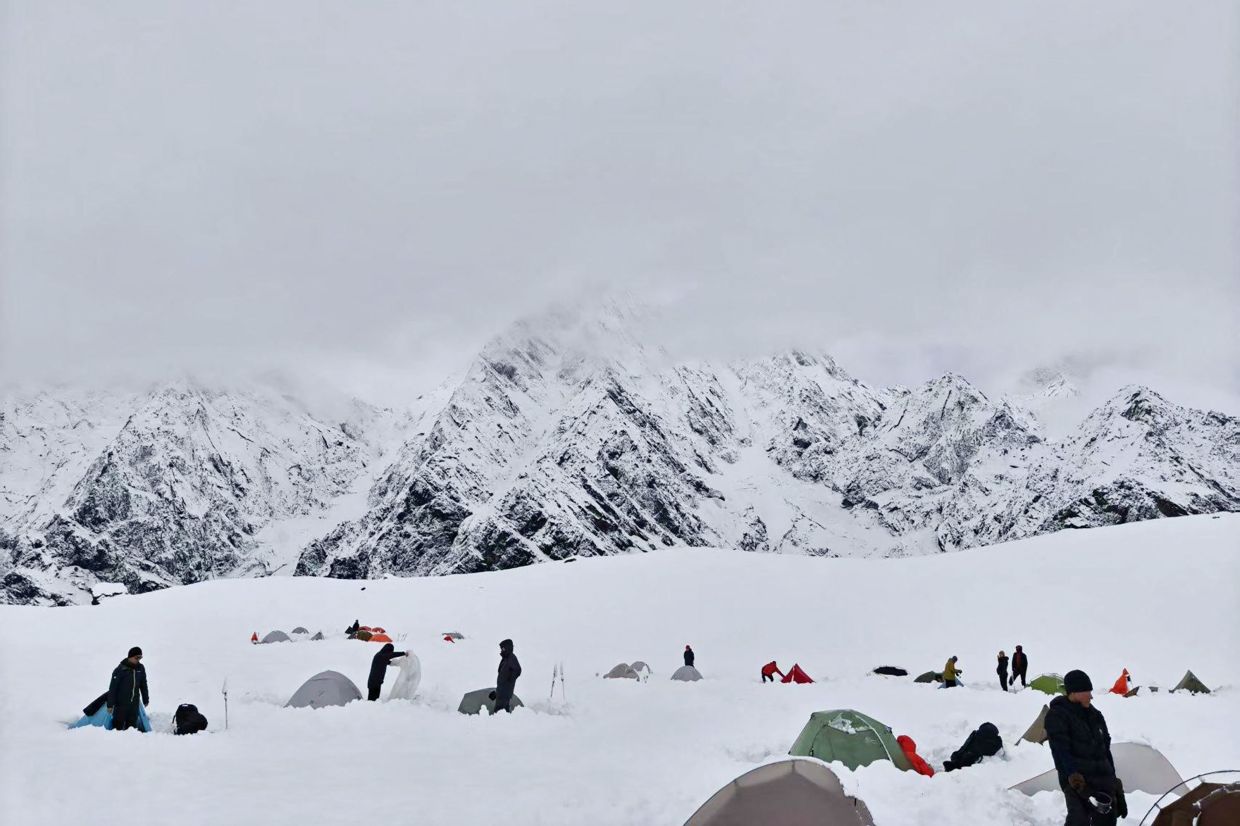 Hikers amid deep snow at Tangxiang camp in the Karma Valley of the Tibet Autonomous Region following a sudden heavy snowfall in the region. One hiker has died and hundreds of others have been rescued after sudden heavy snowfall in China's northwest and western mountain regions over the weekend, state media reported on Monday, October 6. -- Photo by Handout / Courtesy of FeiFei / AFP