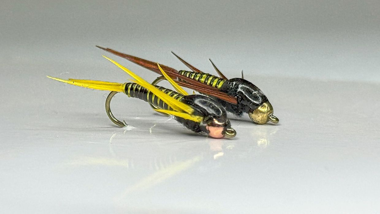 Brightly-tied nymphs are small but deadly, crafted to tempt river fish.