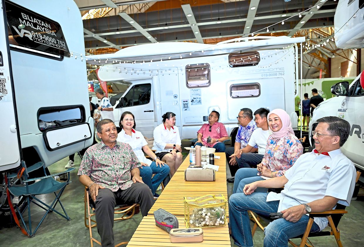 Manoharan (left) and Chan (right) checking out the vendors at TGO in collaboration with KCCM held at MAEPS, Serdang. — RAJA FAISAL HISHAN/The Star