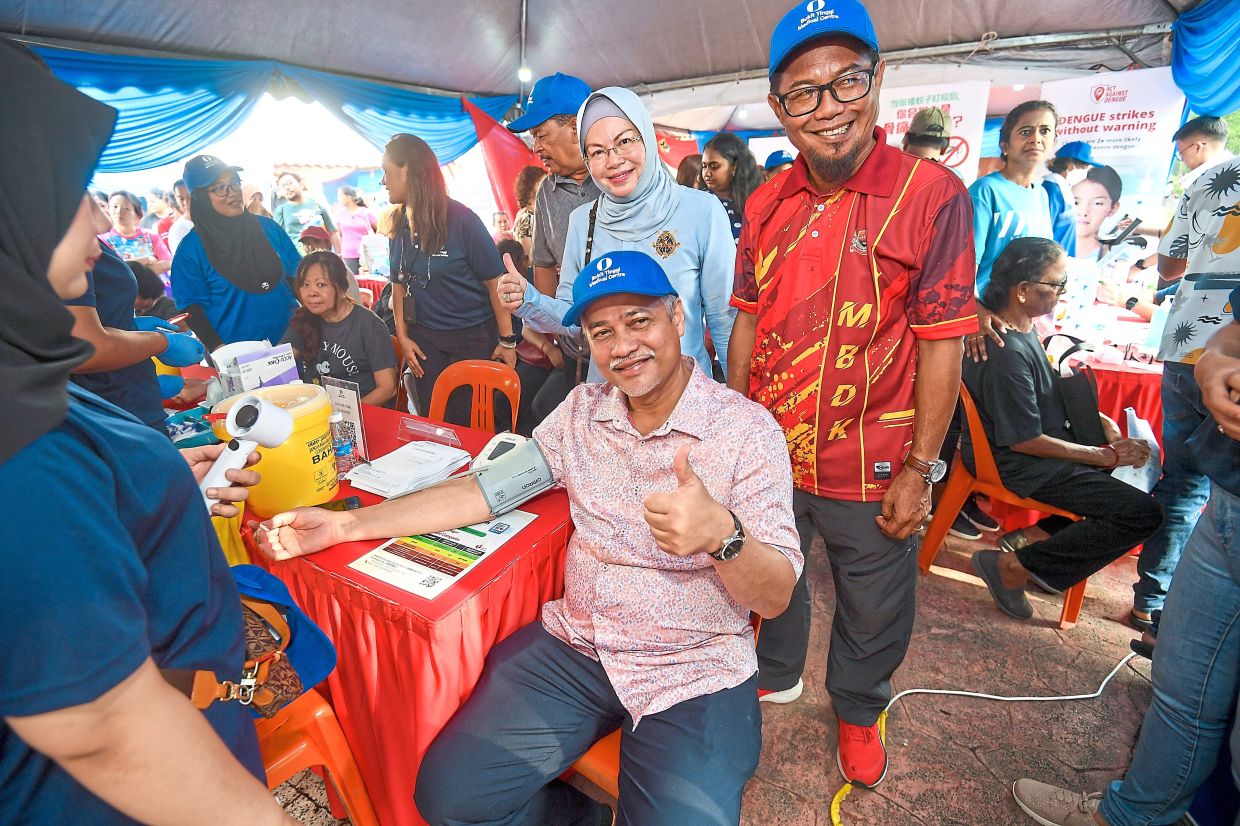 Abd Hamid (seated) checking his blood pressure during the carnival.