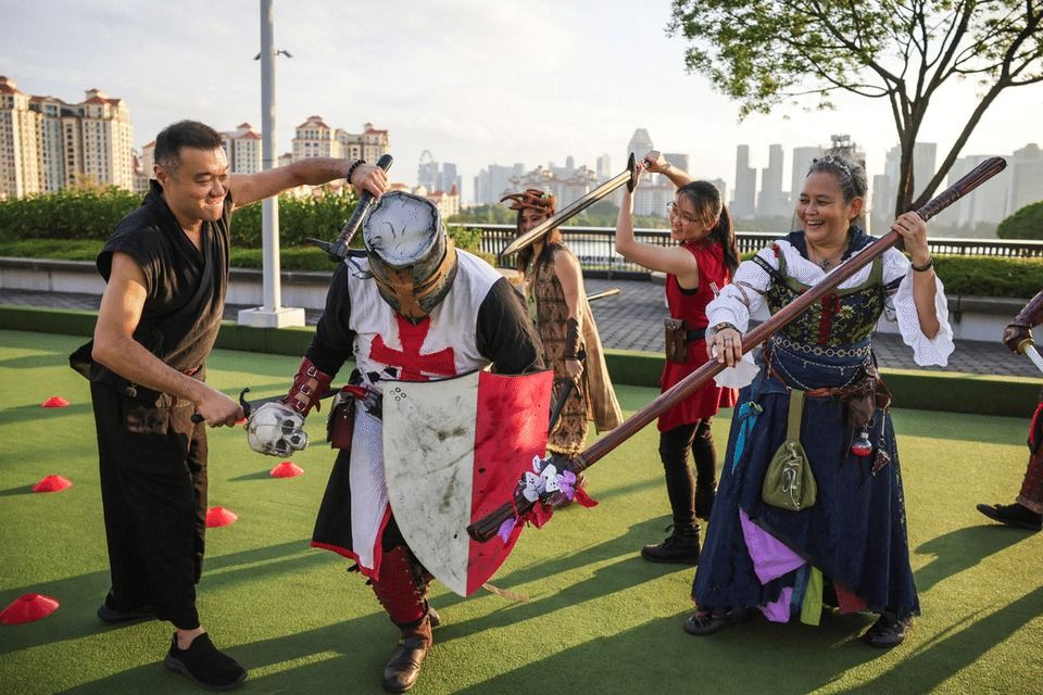 Members of Larp Singapore Community role-playing in their costumes at the Lawn Bowl in Singapore Sports Hub on Aug 16. - ST