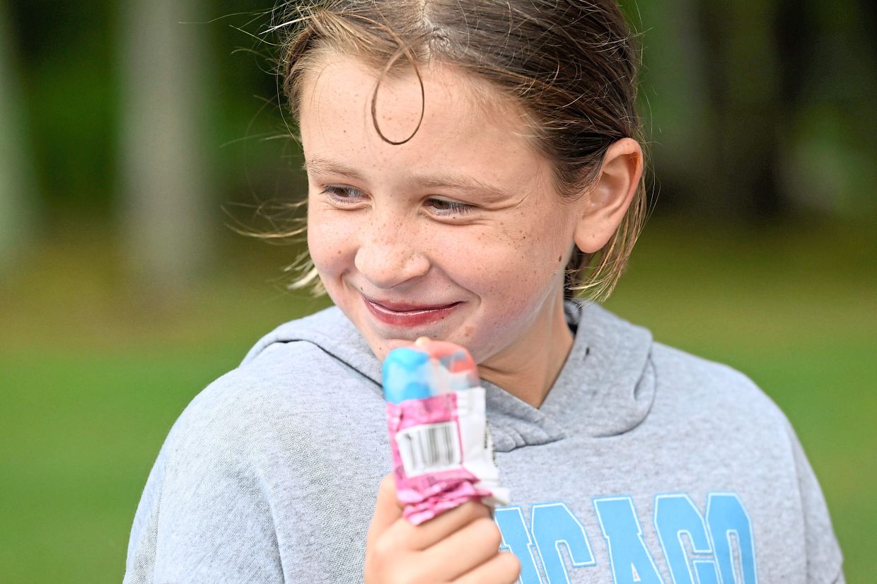 Rozzy Constant enjoys an ice cream from the Norwich Police Department Ice Cream truck.