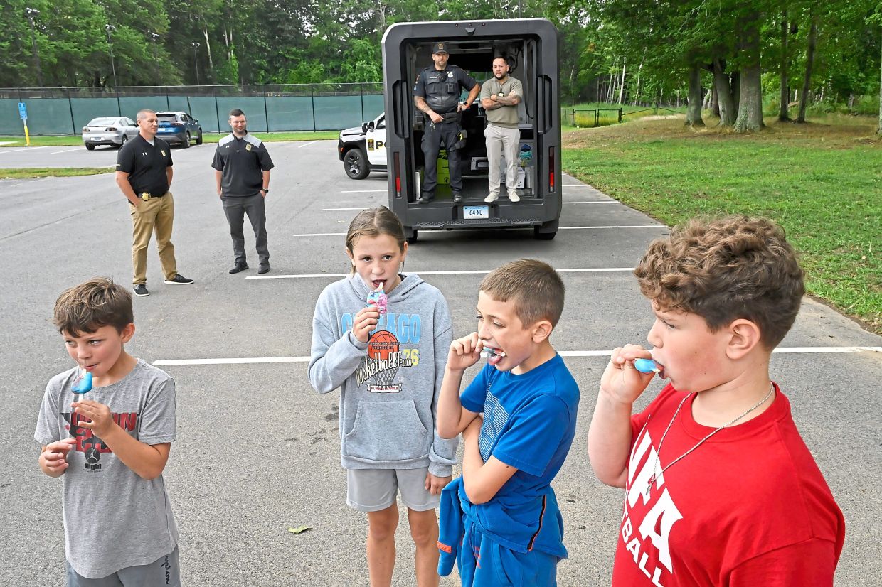 (From left) Siblings Ovid and Rozzy Constant with friends Brady Witts and Travis Thielbar enjoy their ice-cream the police ice- cream truck.