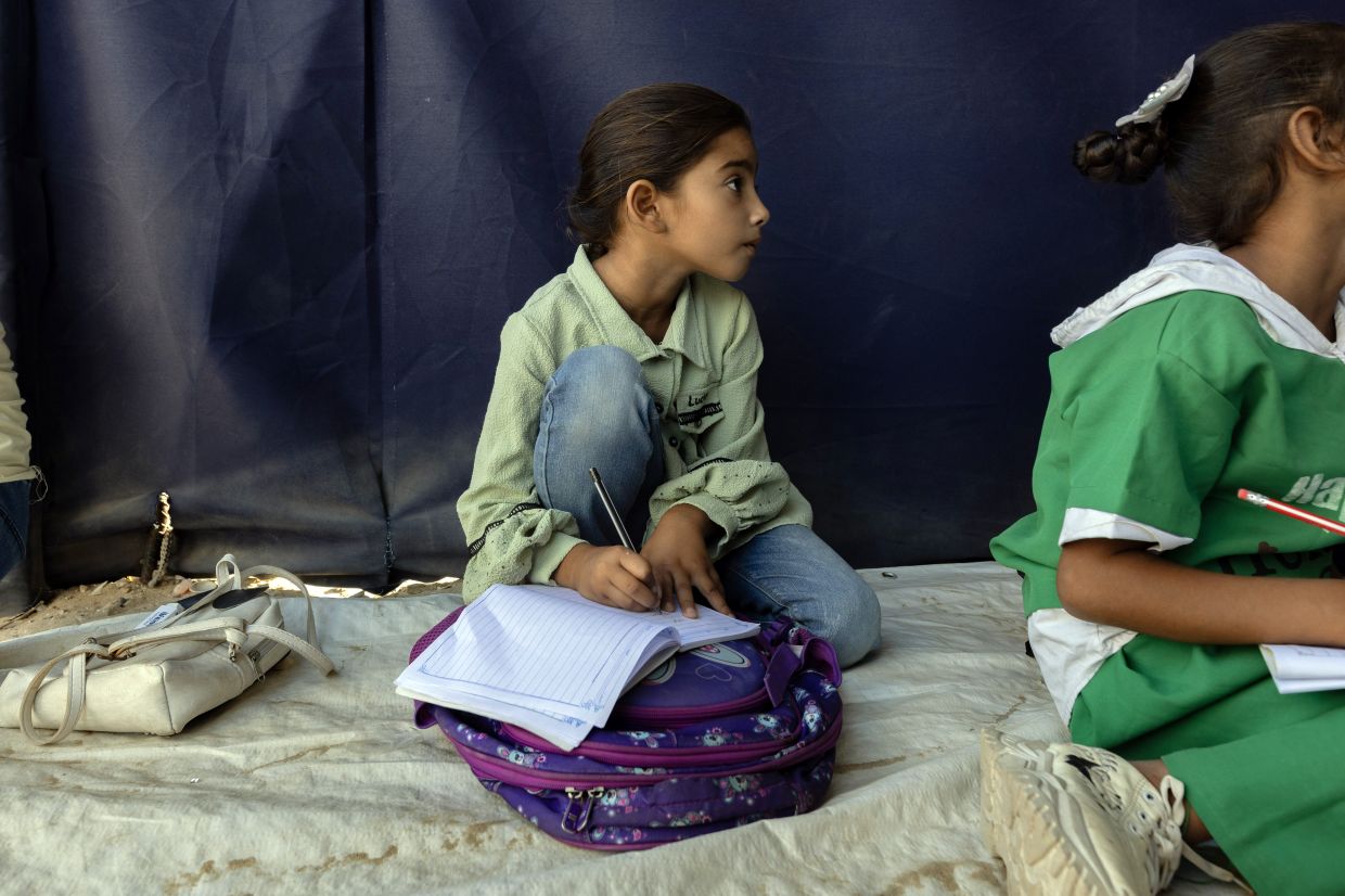 Rateel al-Najjar, 8, at an ad hoc school in the camp where she lives in southern Gaza.— Saher Alghorra/The New York Times
