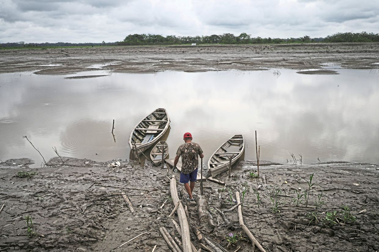 A fisherman walks to his boat in Santa Rosa, Peru, an island on the Amazon River.