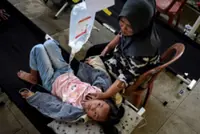 Foodborne illnesses spread as Indonesia govt downplays free meals crisis