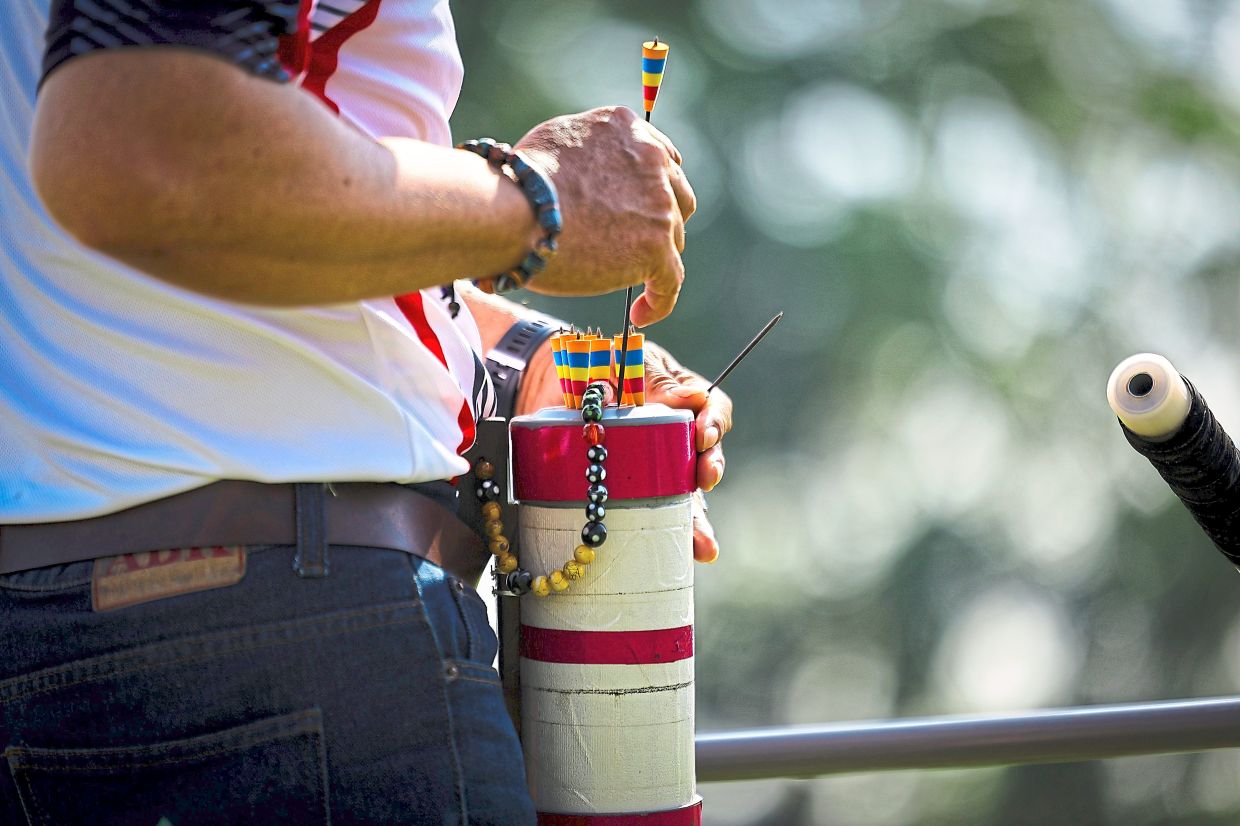 Participants keeping up traditions at the blowpipe competition as part of Borneo Games 2025 in Kuching.