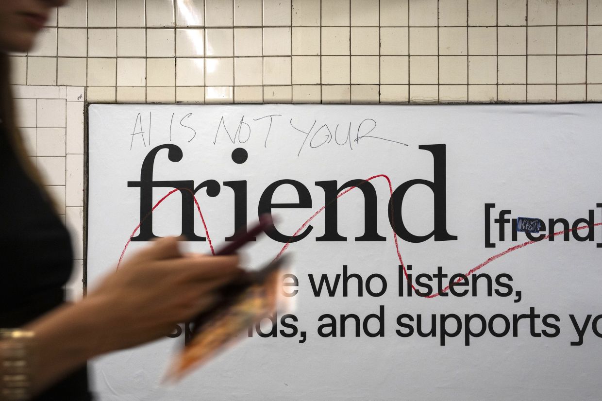 Advertisements for Friend, a wearable companion powered by artificial intelligence, is defaced with “A.I. is not your” written at the top in New York on Oct 4, 2025. — Hiroko Masuike/The New York Times