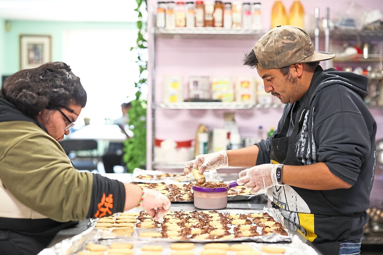 With these learning opportunities, Paola P. (left) and James G. take steps toward independence.