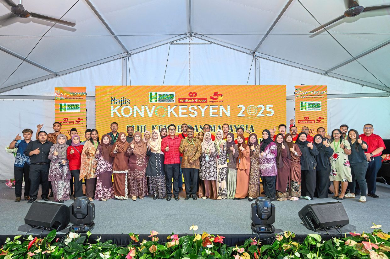 Thomas (centre, in a brown batik shirt) with staff members of the Malaysian Association for the Blind during the graduation ceremony.
