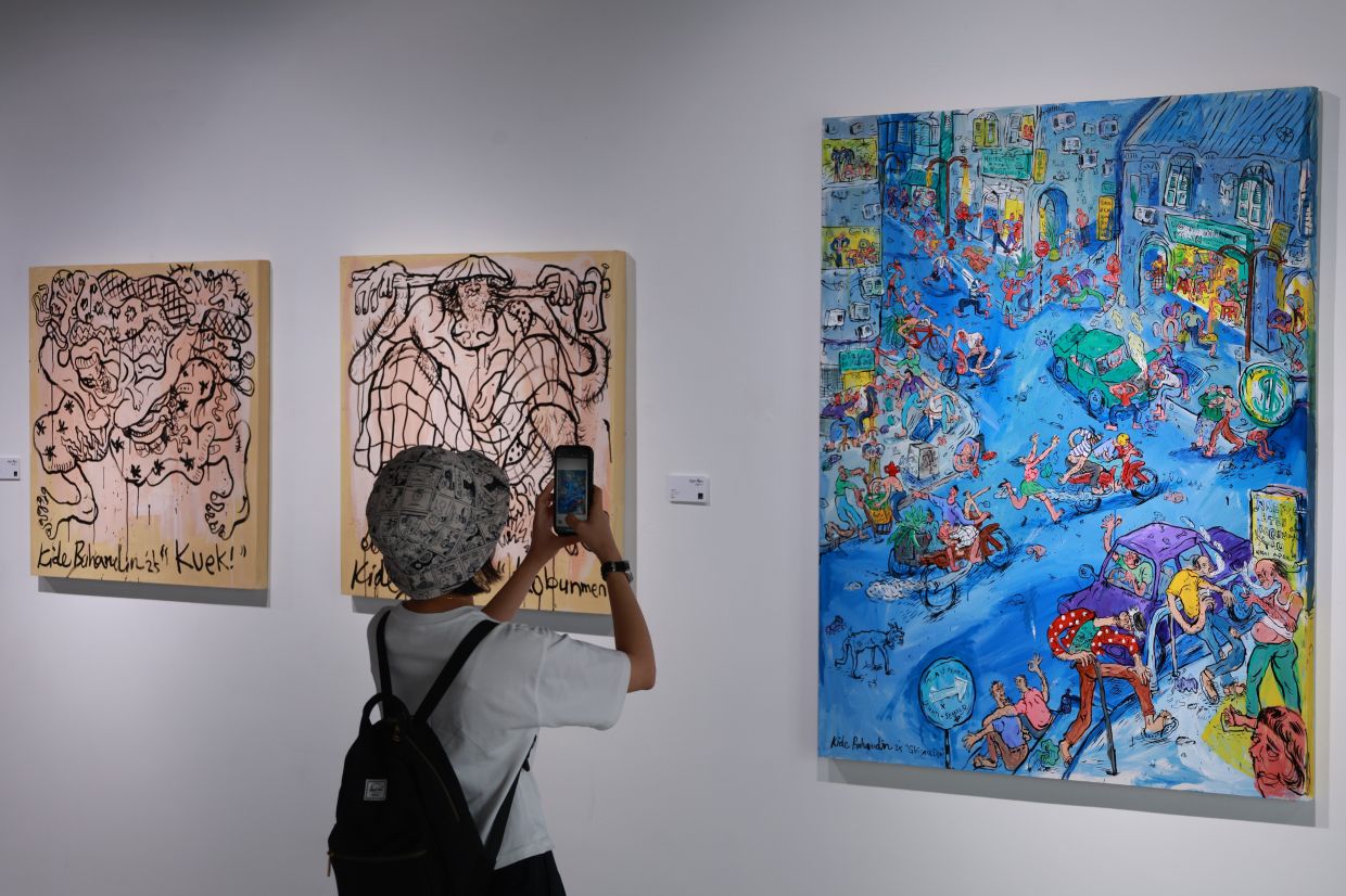 Visitors can't help but take photos of Kide's colourful works.