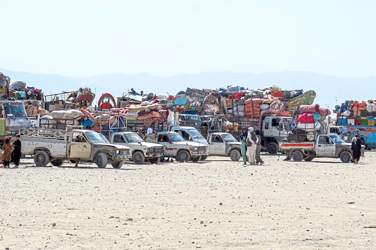 Afghan refugees along with their belongings awaiting deportation to Afghanistan at a holding centre near the Pakistan-Afghanistan border in Chaman. — AFP