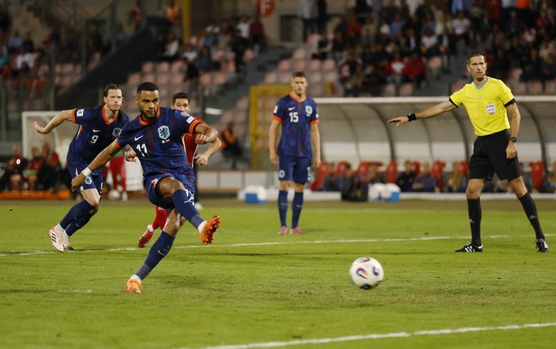 Soccer-Dutch beat Malta 4-0 to open three-point lead in World Cup qualifying group