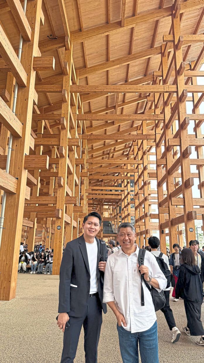 The columnist (right) with his interpreter at the expo, which is held on the Yumeshima Island in Osaka Bay.