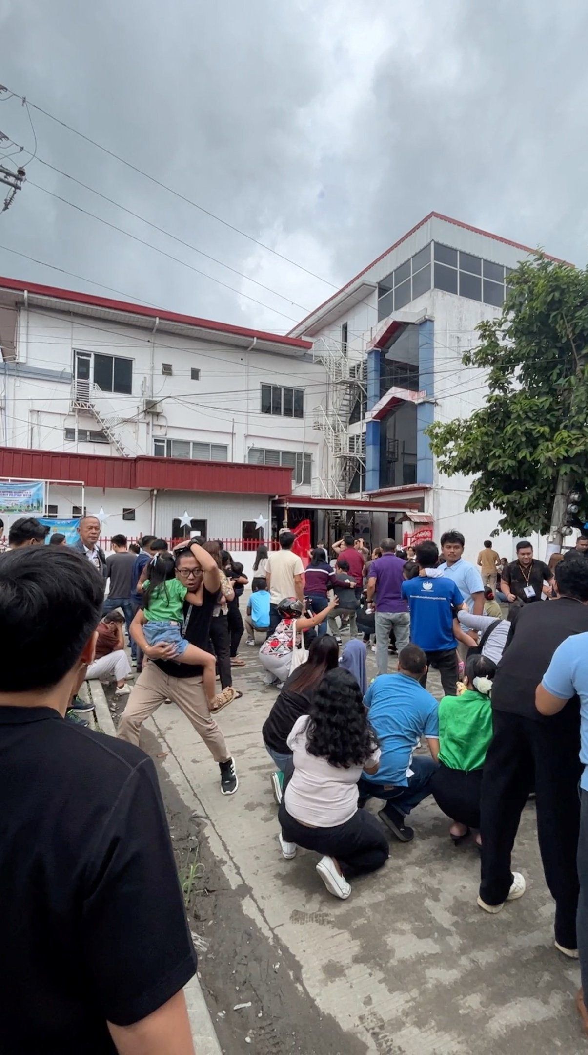People gathering outside the Department of Social Welfare and Development field office in Caraga following the earthquake. - Reuters