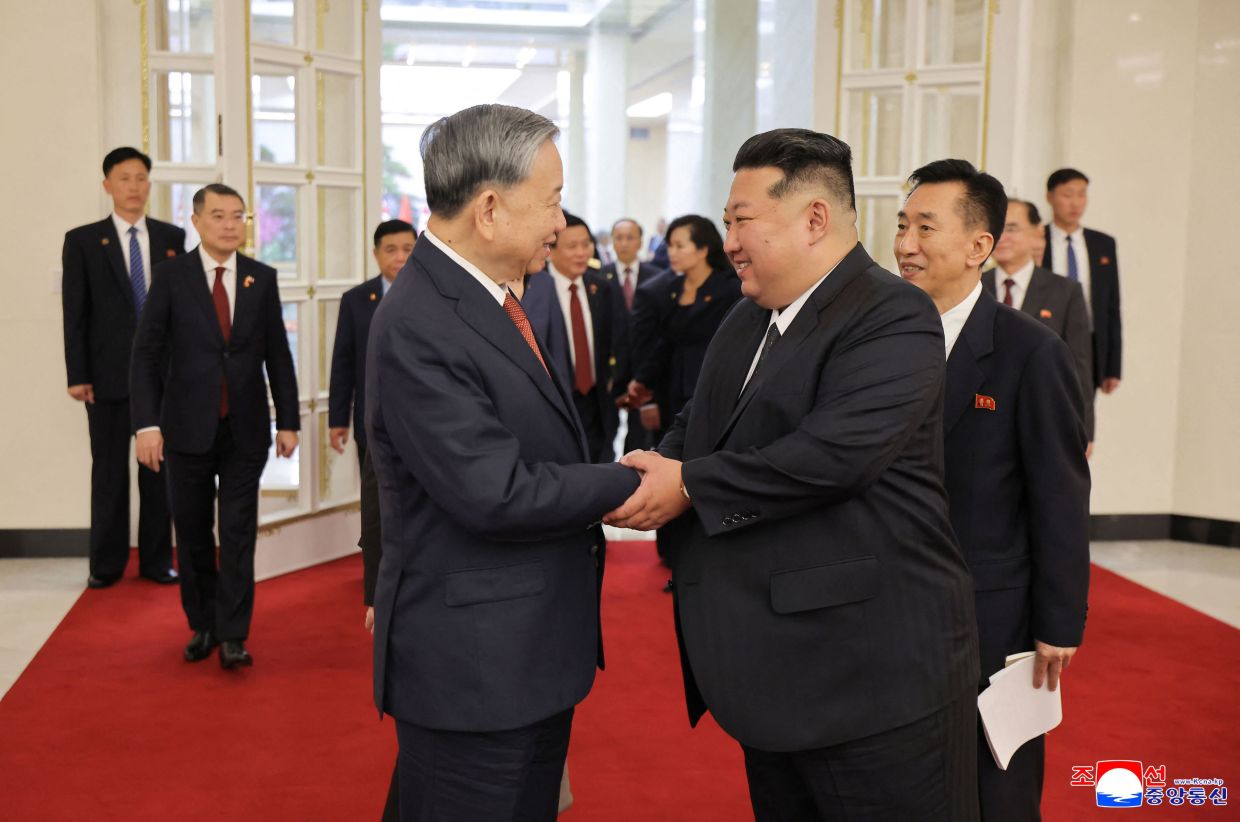 This picture taken on October 9, 2025 and released by North Korea's official Korean Central News Agency (KCNA) on October 10, 2025 shows North Korean leader Kim Jong Un (R) shaking hands with Vietnam's Communist Party General Secretary To Lam after their meeting at the headquarters of the Central Committee of the Workers' Party of Korea in Pyongyang. -- Photo by KCNA VIA KNS / AFP