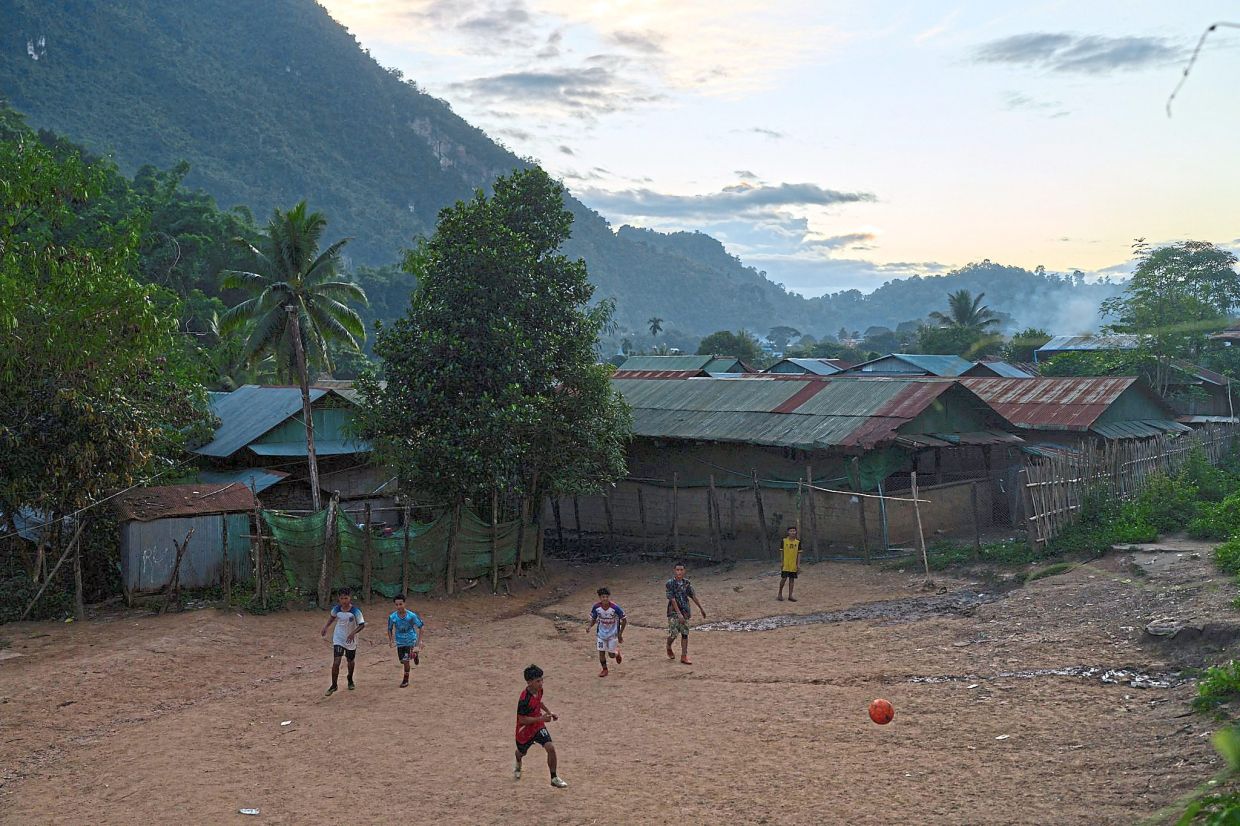 Life goes on: Children playing soccer at the Mae La refugee camp. — AP