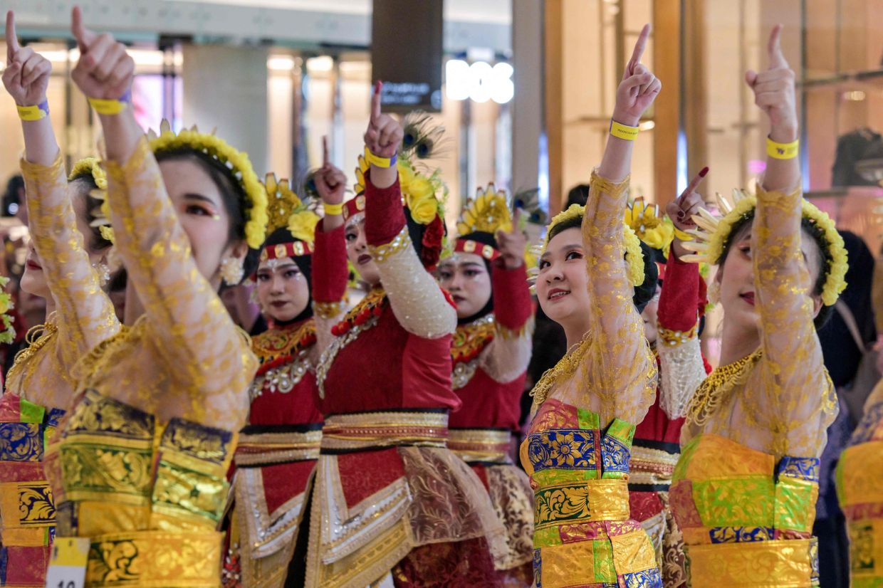 Participants perform during the nationwide dance movement Indonesia Menari 2025 at a mall in Surabaya on Sunday, October 12, 2025. -- Photo by Juni KRISWANTO / AFP