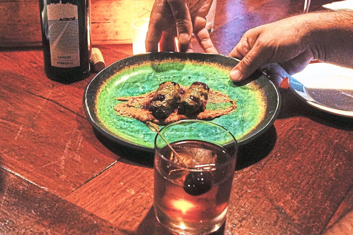 A Dolma appetizer, created with locally foraged grape leaves, are served to a patron at the Black Trumpet restaurant.