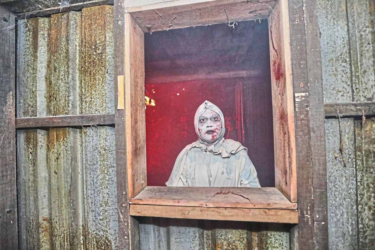 A robed phantom stands still in the shadows at Nights of Fright 11. - Yap Chee Hong