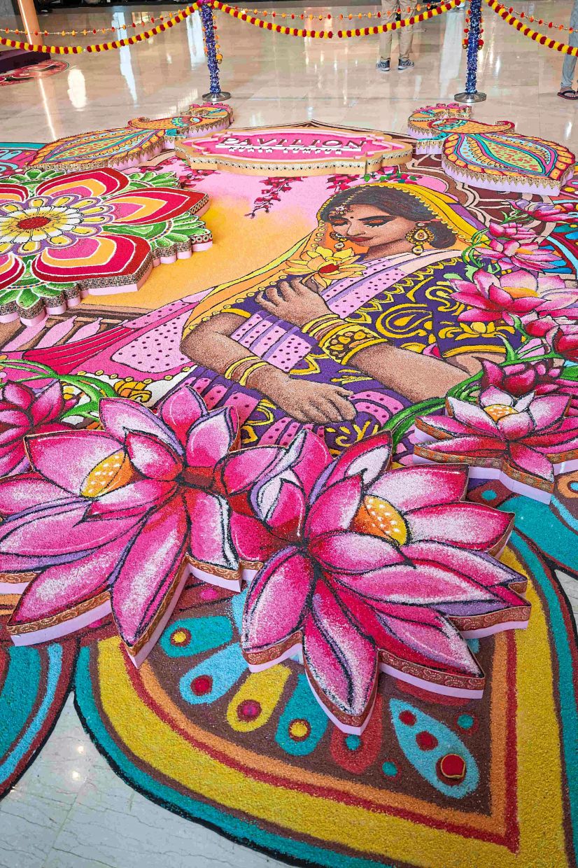 The image of an Indian woman surrounded by flowers is a captivating feature of the kolam set up at Pavilion Kuala Lumpur.