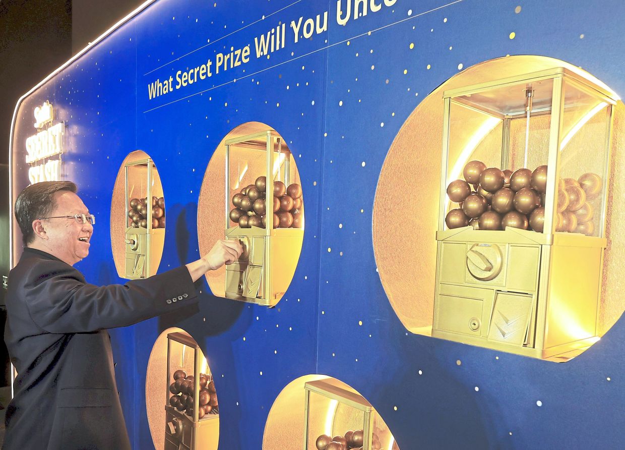 Chan trying his luck with a gachapon.