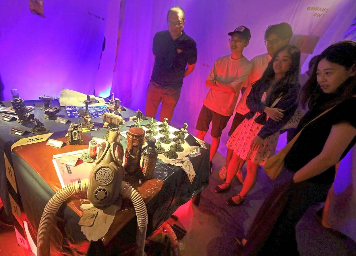 Visitors study the small details on display – each one a clue that invites you to piece together a story of your own. Photo: The Star/Azlina Abdullah