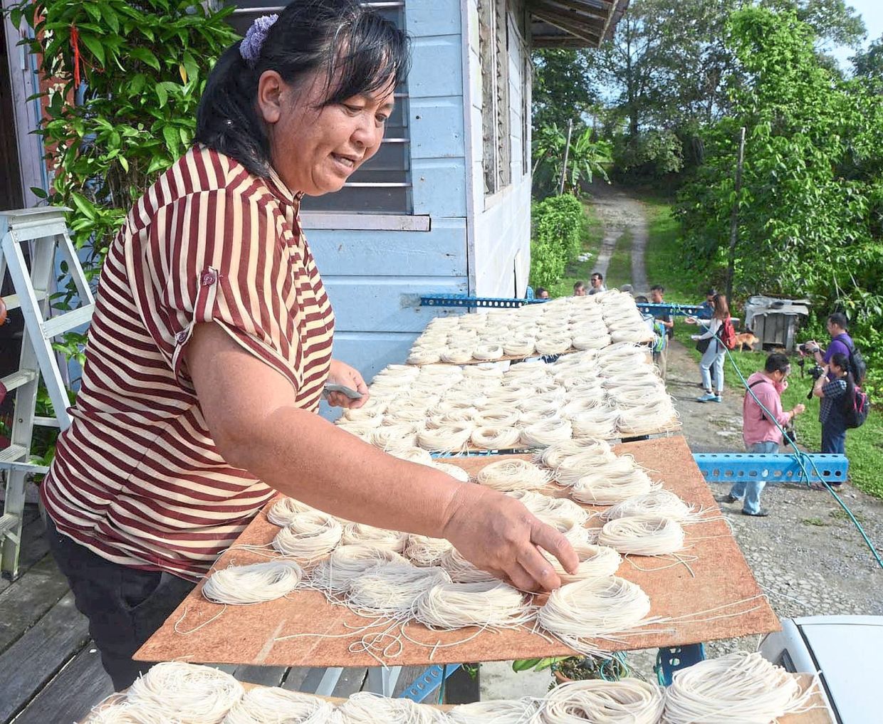 The noodles are wound into bunches for further drying under the sun.