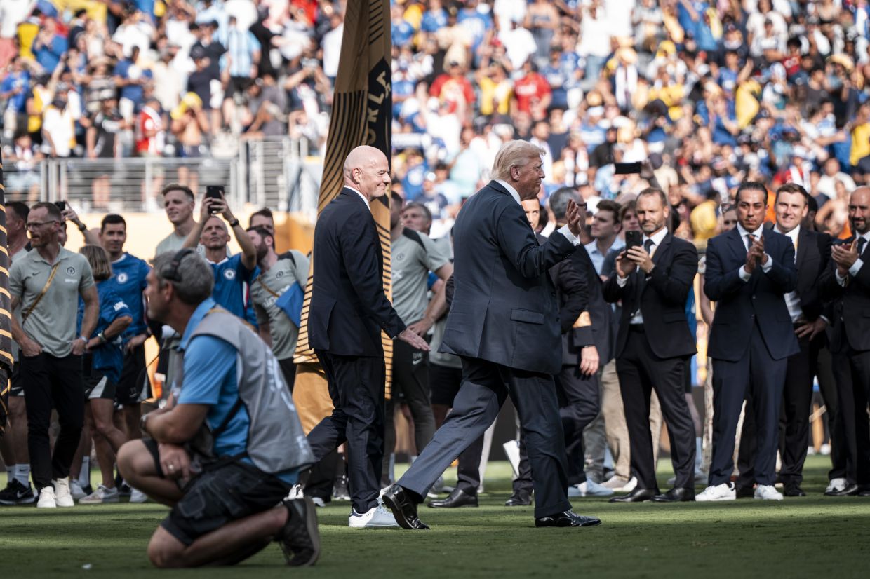 Infantino trailing behind Trump as they visited the pitch following the FIFA Club World Cup final between Chelsea and Paris Saint-Germain at MetLife Stadium in East Rutherford, New Jersey, in July. — Haiyun Jiang/The New York Times
