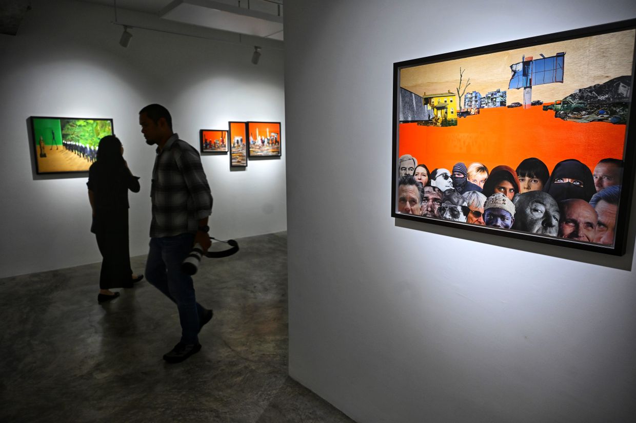 Visitors stroll past Zulkefli's collage works in his '$omeone, $omething, $omewhere' exhibition at Galeri Sasha in KL. Photo: The Star/Raja Faisal Hishan