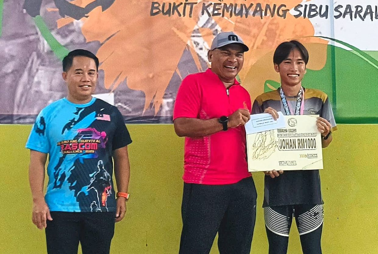 Brig-Jen Jafri (centre) presenting the prize to Wong.