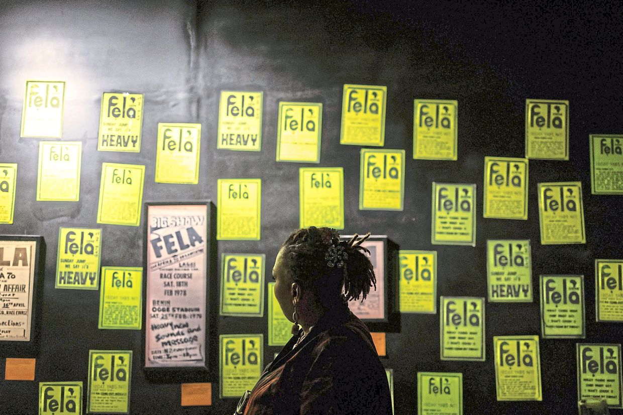 A wall of vintage Fela Kuti posters and concert flyers displayed at the exhibition. Photo: AFP