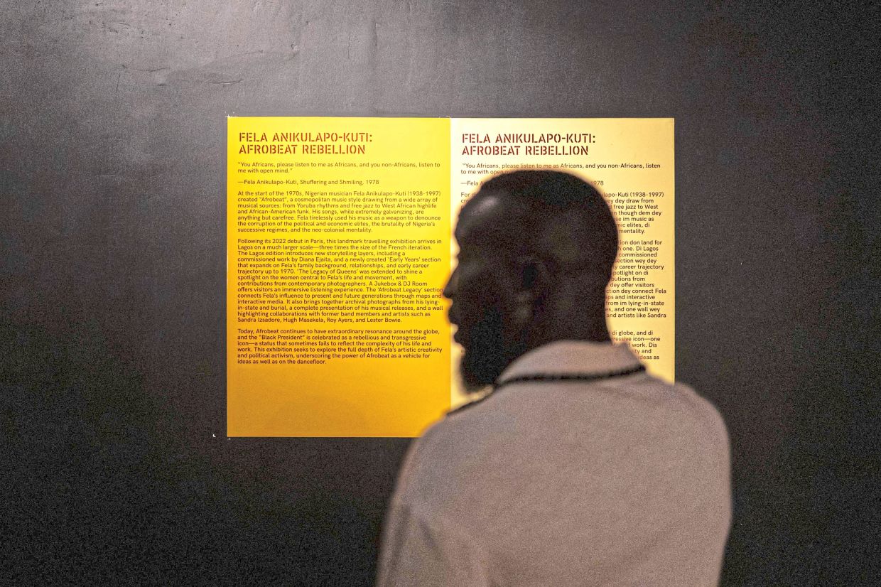 A visitor stands in front the introductory text of the exhibition. Photo: AFP