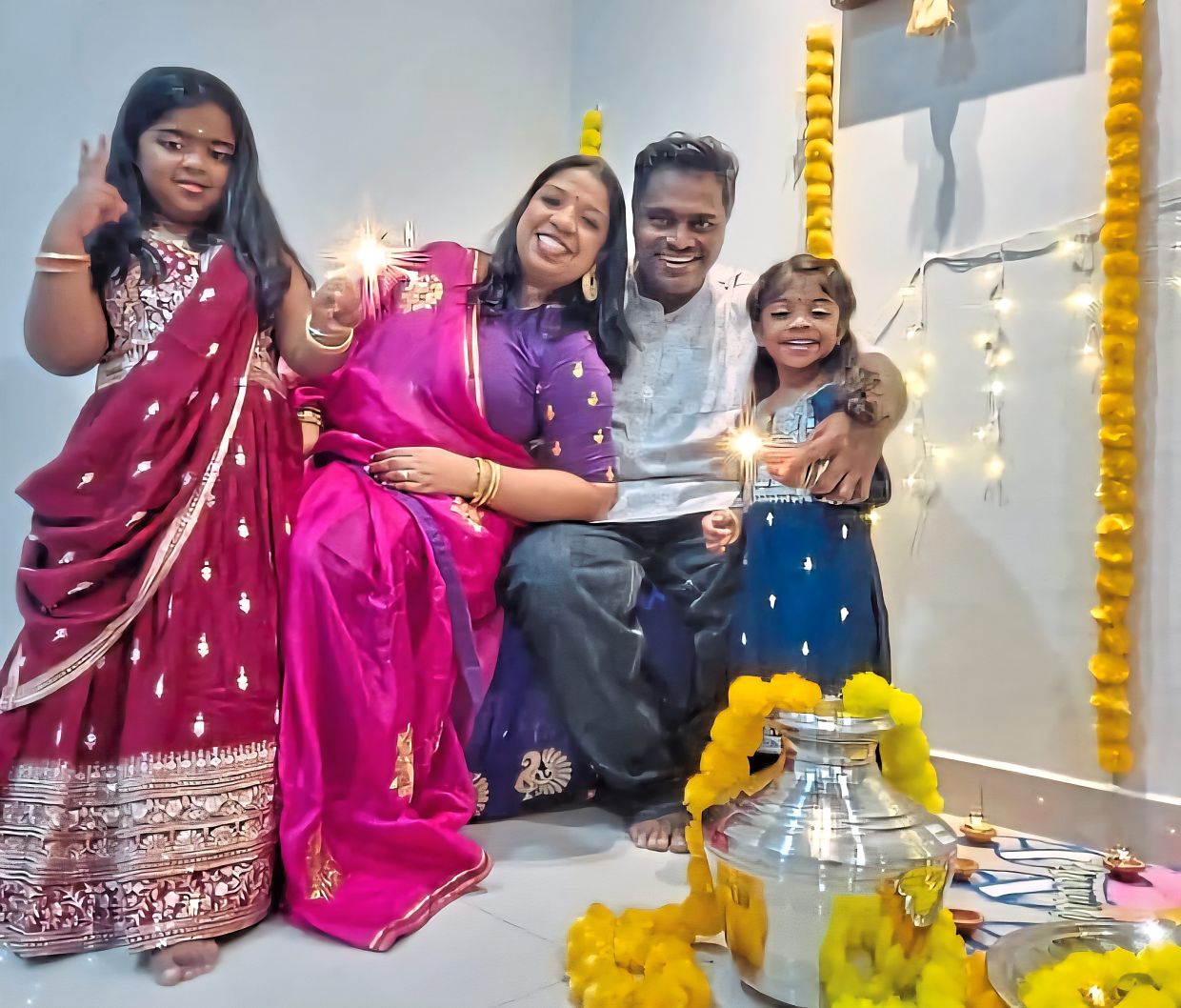 (From second left) Uma and Anbalagan with their daughters Abinayaa (left) and Aradhanaa at their new home in Shah Alam.