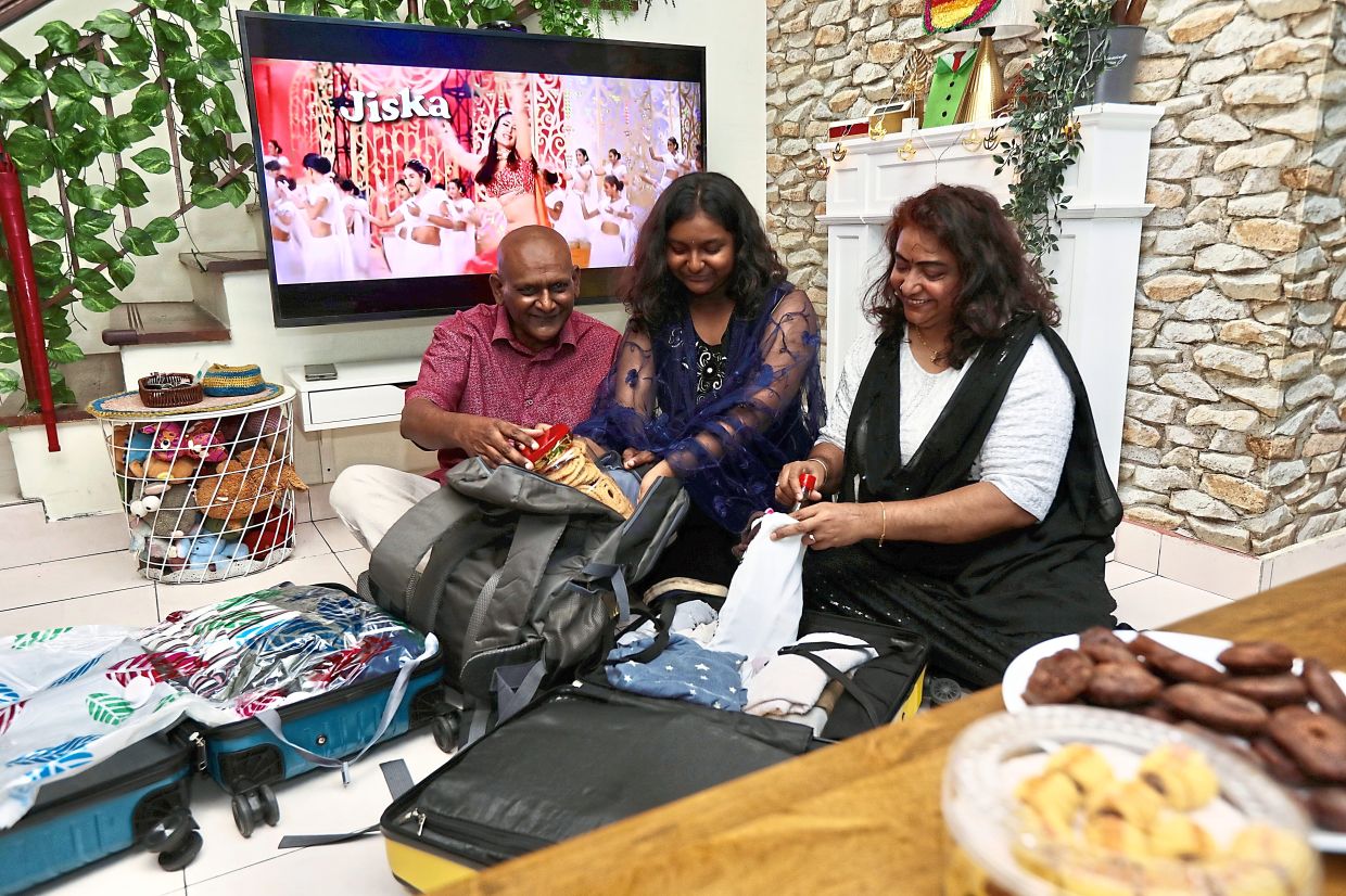 (From left) Sivaparakasu, Sunetra and Saraswathy preparing for their trip to New Delhi and Punjab. — LOW LAY PHON/The Star
