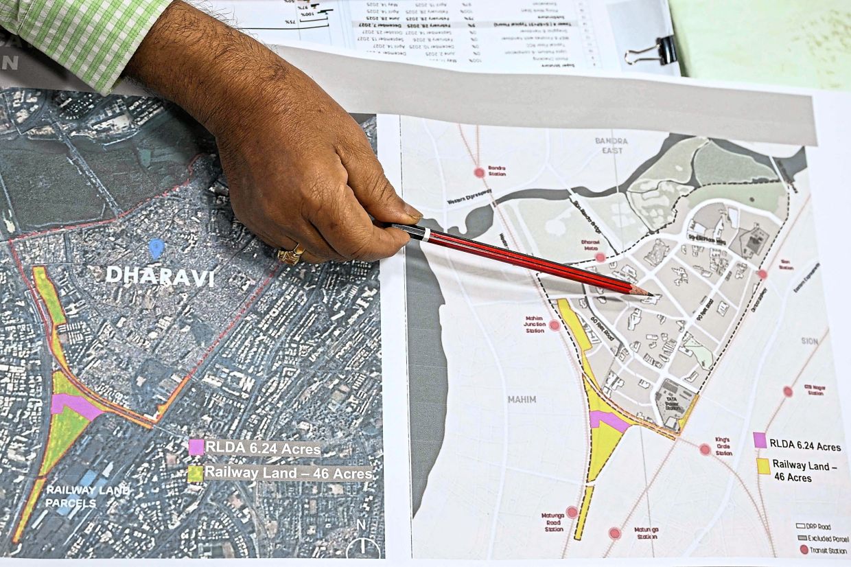 An official presenting the proposed reconstruction blueprint of Dharavi as part of an urban renewal project aimed to redevelop the slum settlement in Mumbai.