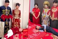 Why little Chinese boy rolls across newlyweds’ bed while chanting blessings on wedding day