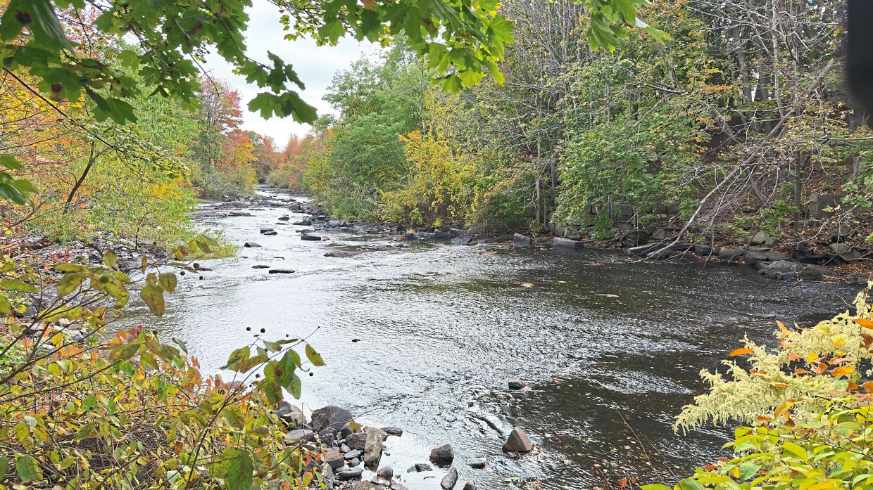 Fall foliage frame the banks of Mousam River in Kennebunk, Maine.