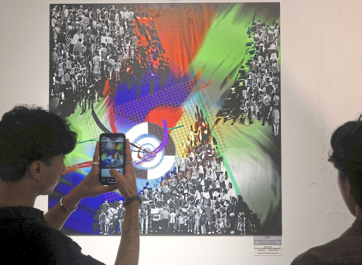 Bancon's work titled 'Ego-zero #1' draws the attention of a gallery visitor. Photo: The Star/Azlina Abdullah 
