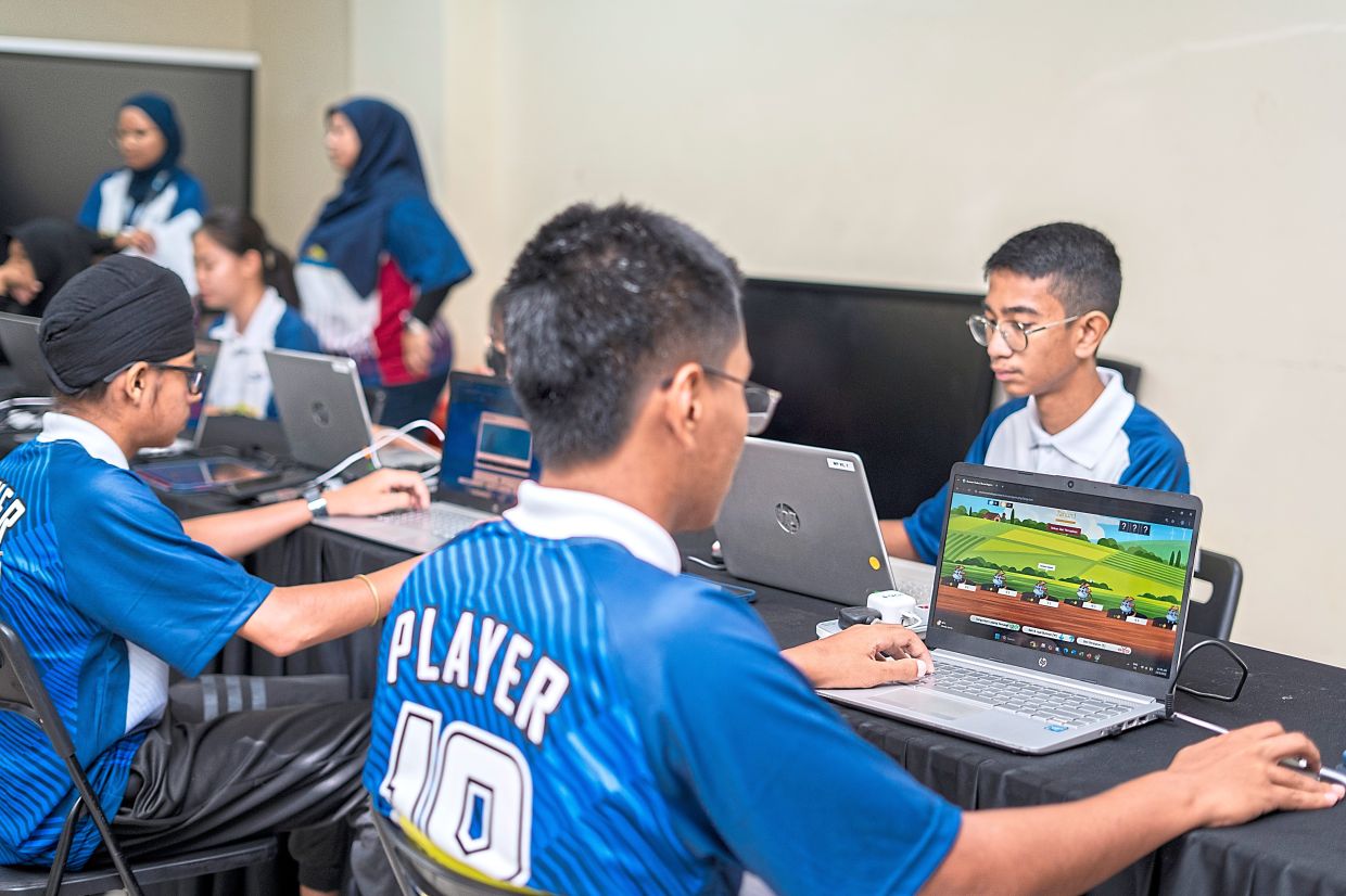Students playing Burmon Trader which teaches strategic thinking and decision-making.
