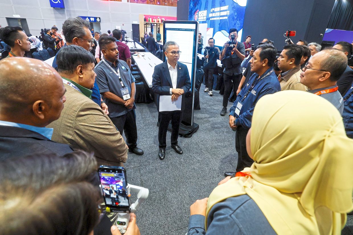 Planning ahead: Fahmi (centre) visiting the International Media Centre for the 47th Asean Summit and Related Summits, scheduled to be held from Oct 26 to 28 at Kuala Lumpur Convention Centre. — Bernama