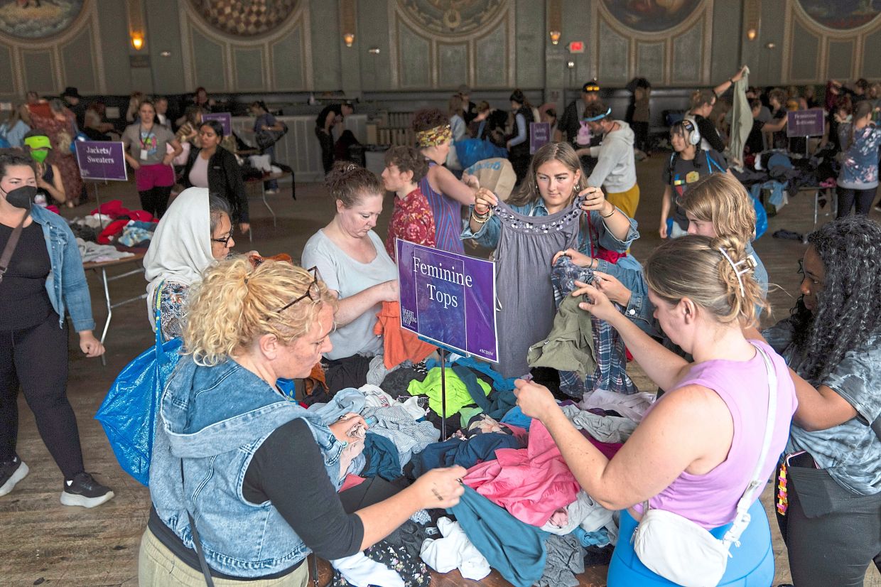 Attendees look at items during a clothing swap in Portland.