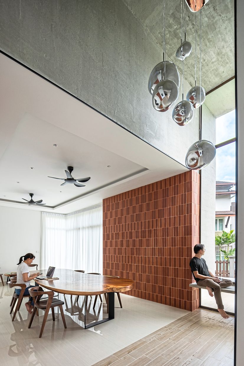 A double-height volume anchors the dining space where light, texture and tactility converge.